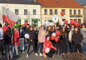 Grupa uczniów pozuje do zdjęcia na Placu Kościuszki.